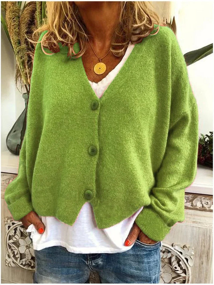 Elegant women's oversized V-neck cardigan sweater for fall & winter. Long sleeve, button front, versatile style.