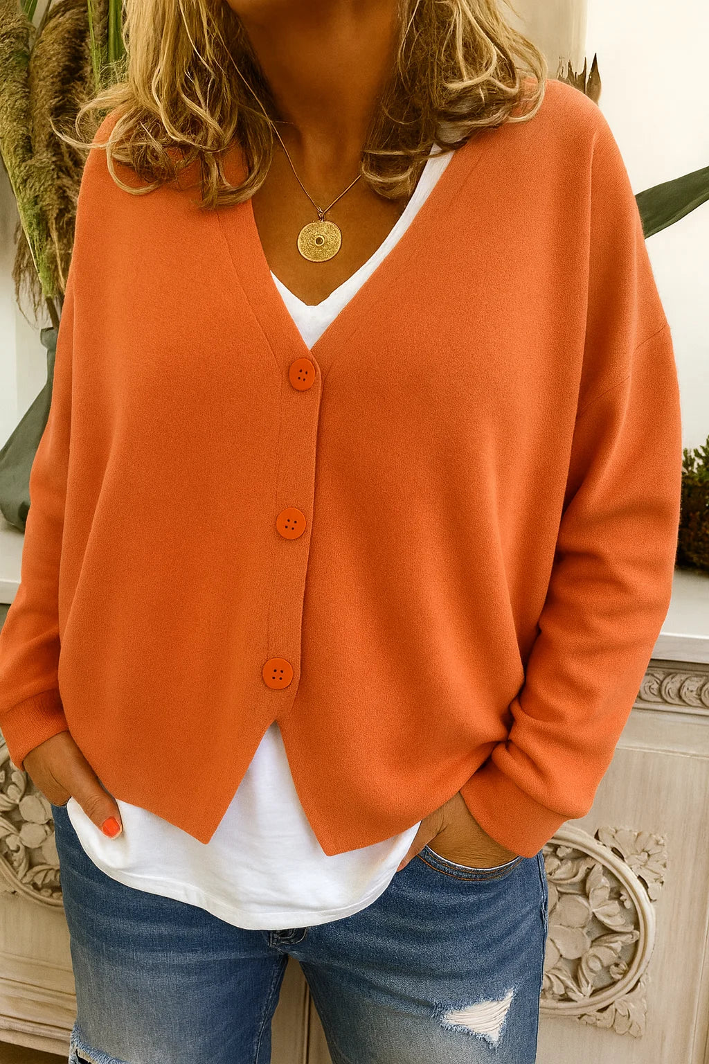 Women's oversized V-neck cardigan sweater with long sleeves & button front. Ideal for casual fall & winter layering.
