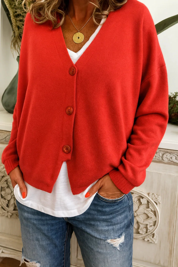 Warm women's oversized V-neck cardigan, long sleeve, button front. Essential fall fashion & winter style sweater.