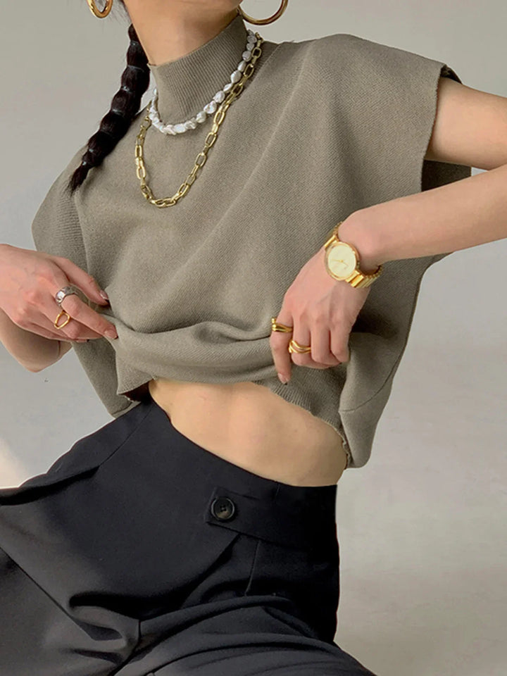 Women's stylish mock neck knit top, featuring padded cap sleeves for a contemporary, elegant vibe.