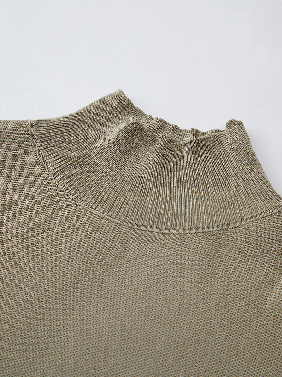 Women's structured fashion top, mock neck, padded cap sleeves, knit for a professional appearance.