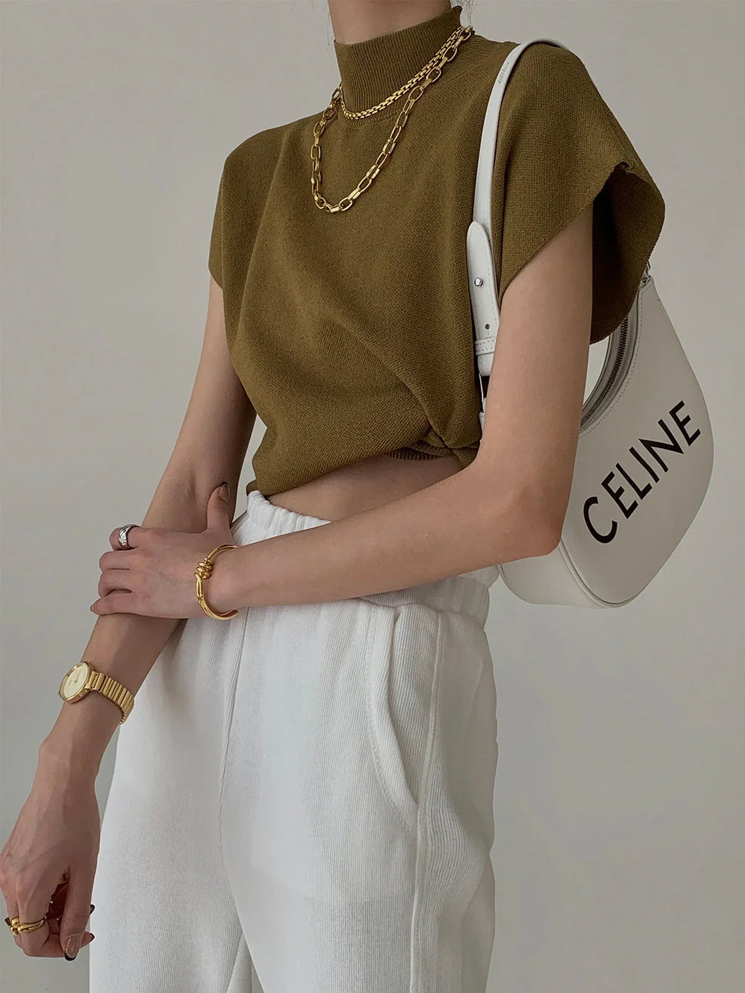 Chic women's mock neck top, padded shoulders & cap sleeves, knitwear designed for sophisticated style.