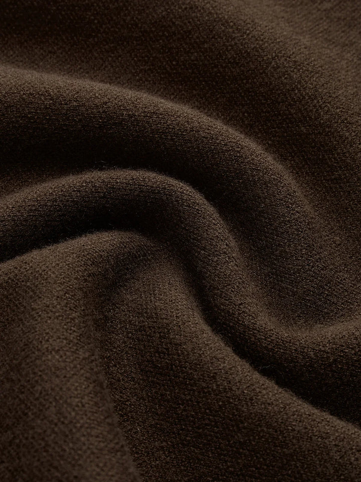 Stylish women's mock neck knit with padded cap sleeves, perfect for versatile, sophisticated outfits.