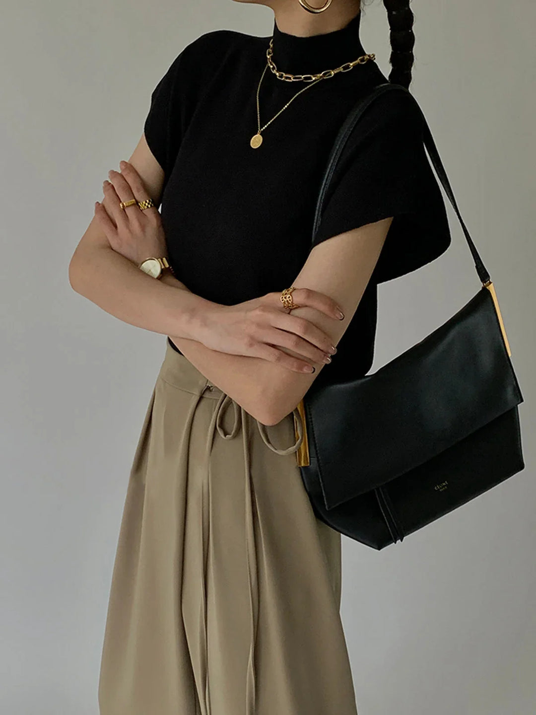 Women's refined padded shoulder cap sleeve mock neck top, ideal for office and elegant outfits.
