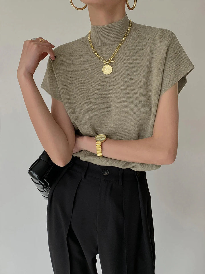 Sophisticated women's knit top, mock neck, and padded cap sleeves, perfect for office or smart casual.