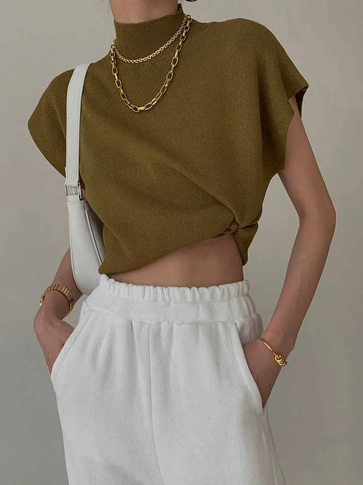 Elegant women's mock neck top with structured padded cap sleeves, versatile fashion knitwear.