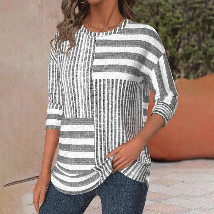 Comfortable women's striped patchwork blouse with 3/4 sleeves and crew neck. Ideal loose-fit top for everyday fashion.