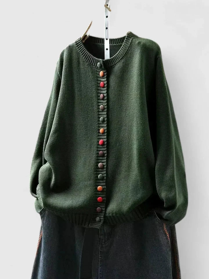 Model wearing women's relaxed fit cardigan sweater with multi-color buttons for chic everyday style.