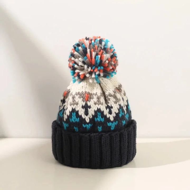 Cozy women's winter hat with a beautiful snowflake pattern, a cute pom-pom, and a comfortable ribbed cuff.