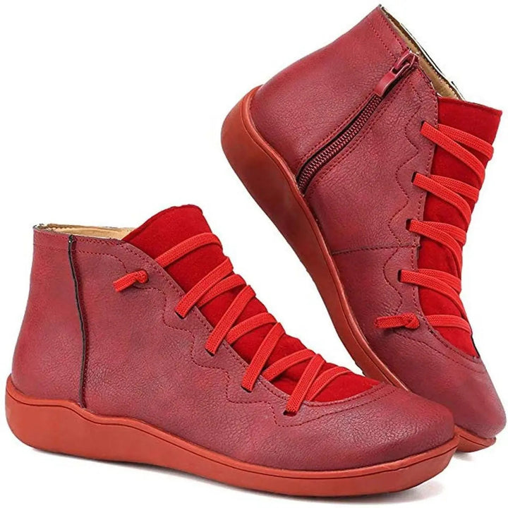 Stylish women's flat ankle boots featuring a practical side zip and classic lace-up design.