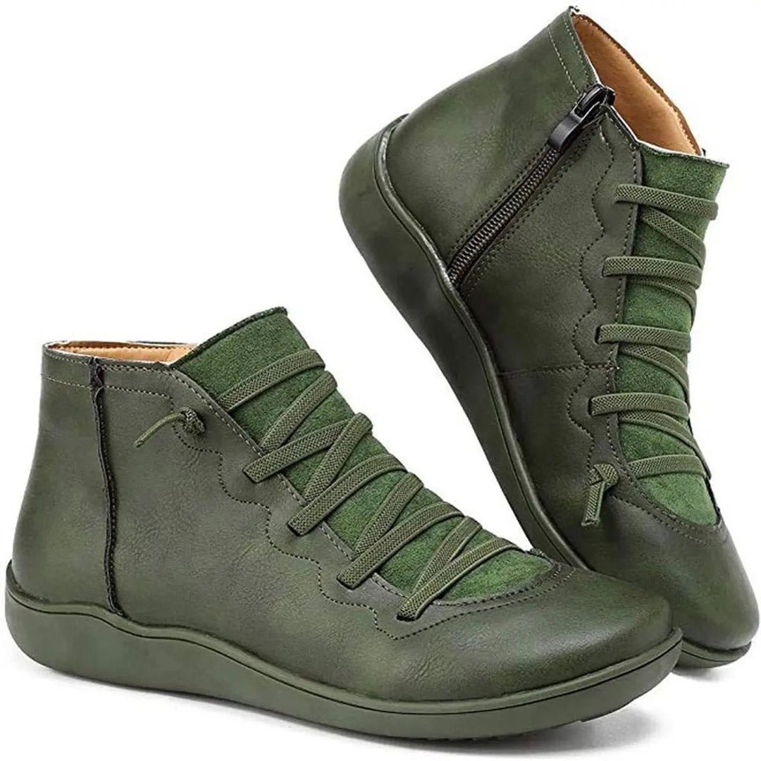 Side view of women's flat ankle boots, showing convenient side zipper & sturdy, comfortable design.