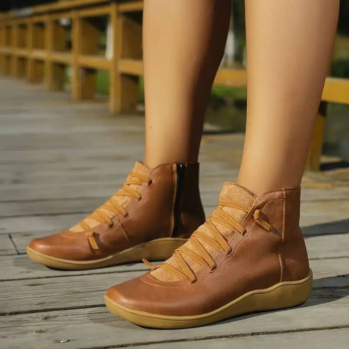 Chic women's flat ankle boots with secure lace-up closure & easy side zipper. Great for autumn fashion.