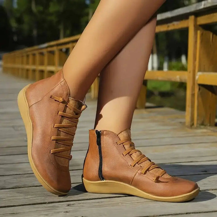 Fashionable women's black flat ankle boots, offering both lace-up style & a practical side zip closure.