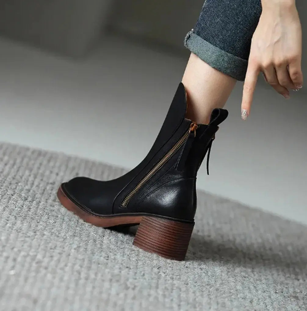 Elegant women's leather ankle boots featuring a chic block heel & easy side zip for a sophisticated autumn look.