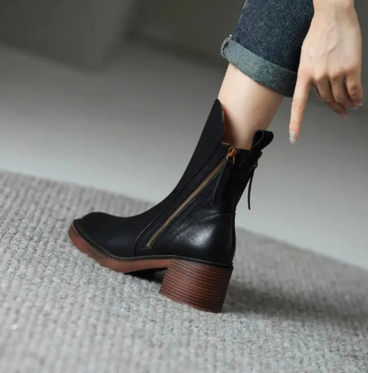 Elegant women's leather ankle boots featuring a chic block heel & easy side zip for a sophisticated autumn look.