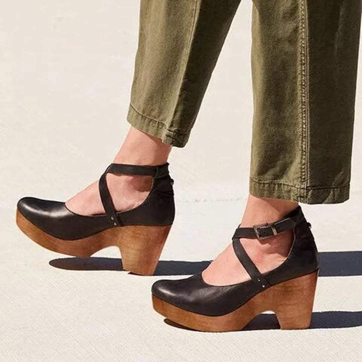 Women's black closed-toe Mary-Jane platform wedge heels with adjustable ankle strap for elegant comfort.