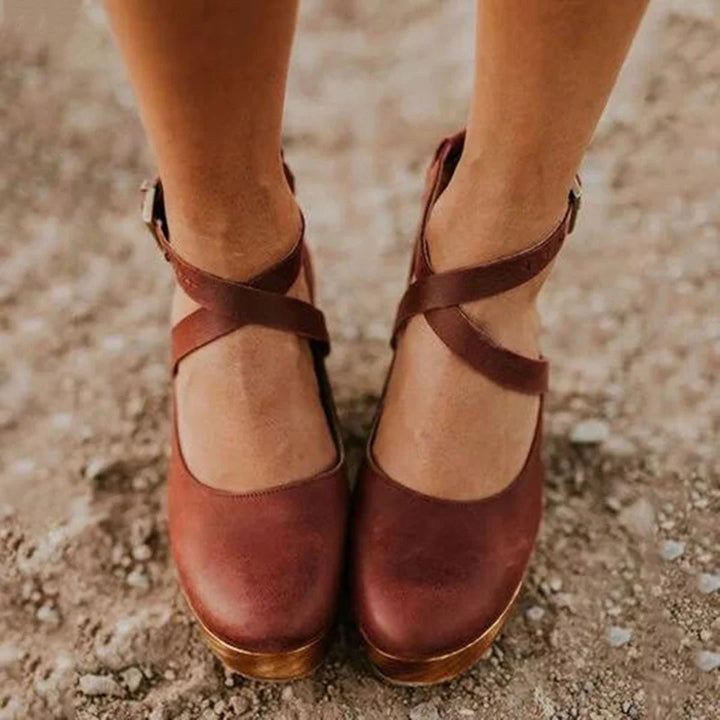 Elegant women's closed-toe Mary-Jane heels, featuring a comfortable wedge platform and secure ankle strap design.