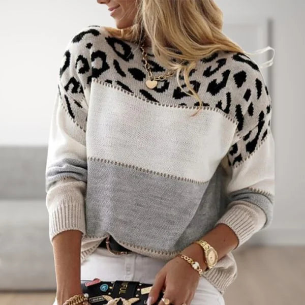 Elegant women's drop shoulder sweater featuring bold leopard print, color block, & ribbed cuffs.