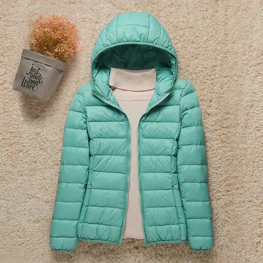 Women's lightweight hooded quilted puffer jacket, great for outdoor activities, travel, and easy packing.