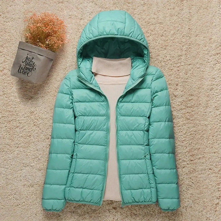 Women's lightweight hooded quilted puffer jacket, great for outdoor activities, travel, and easy packing.