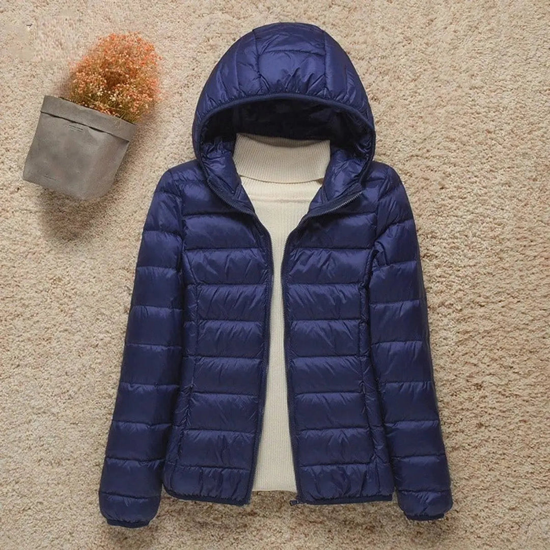 Stylish women's quilted puffer jacket with hood, offering cozy warmth for autumn & winter fashion.