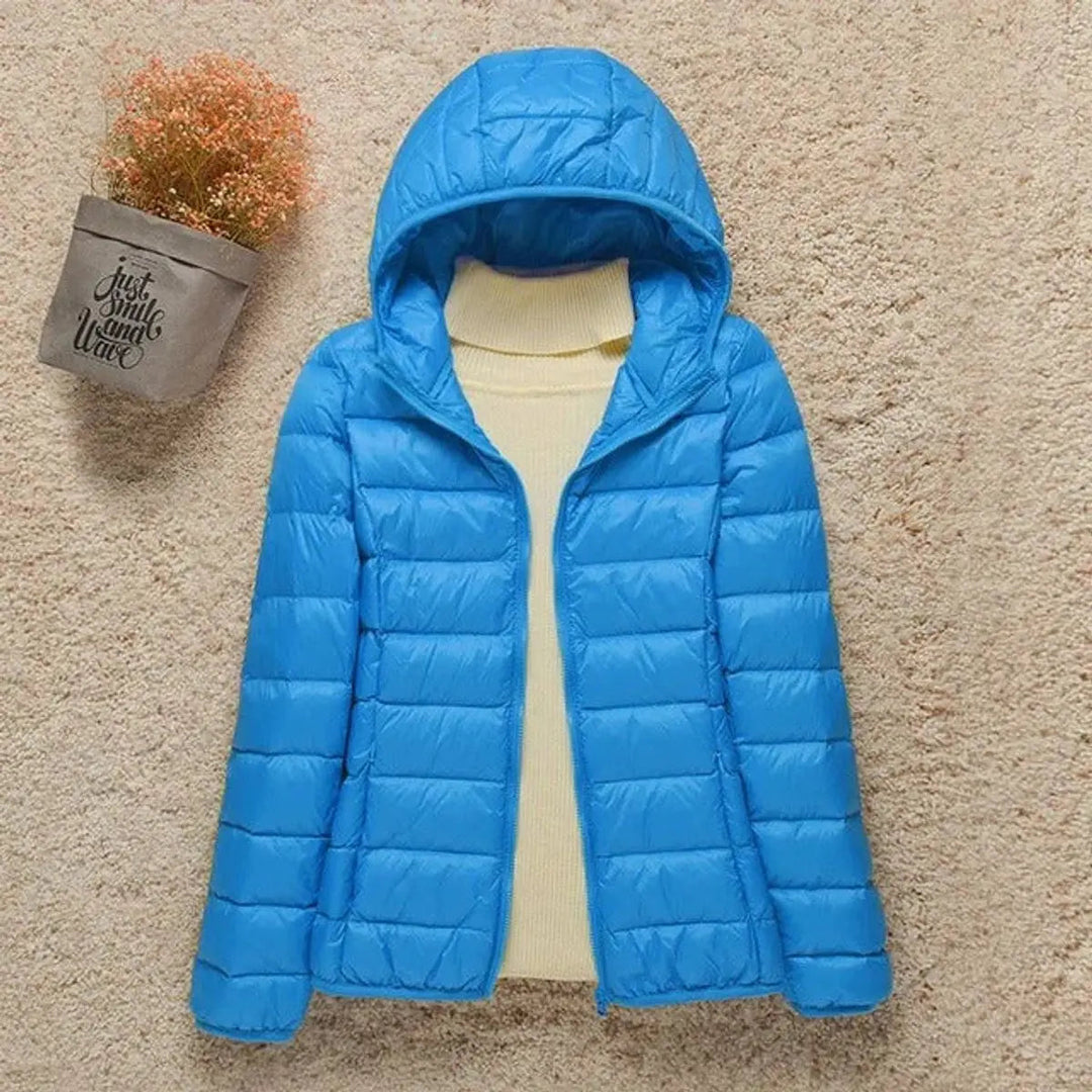 Versatile women's lightweight hooded puffer jacket, ideal for travel, outdoor activities & casual wear.