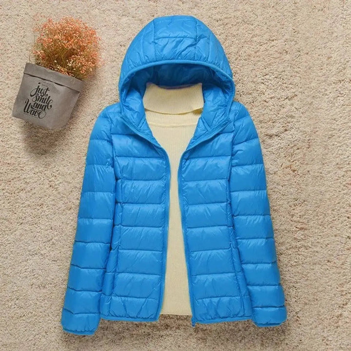 Versatile women's lightweight hooded puffer jacket, ideal for travel, outdoor activities & casual wear.