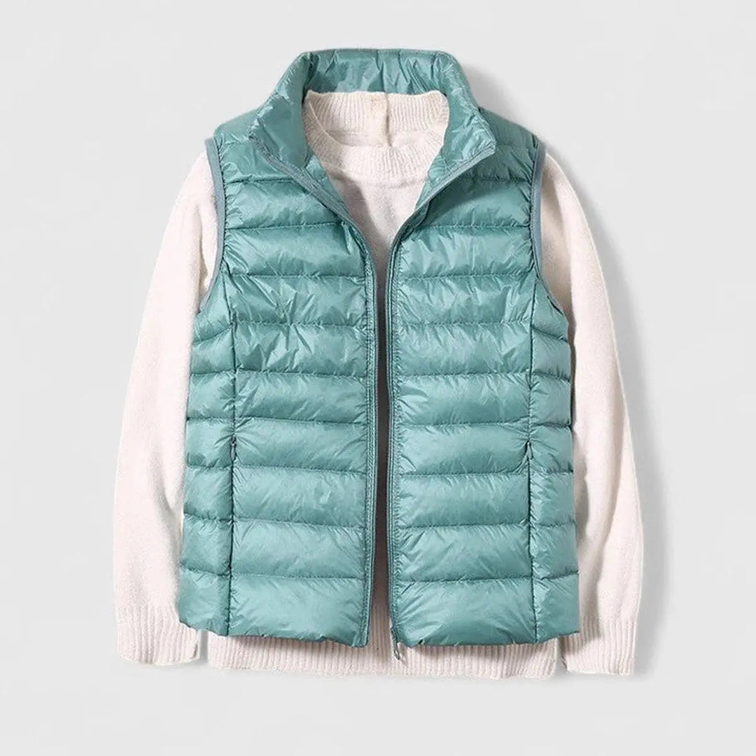 Front view of a women's sleeveless puffer jacket, styled casually, essential layering piece for everyday.