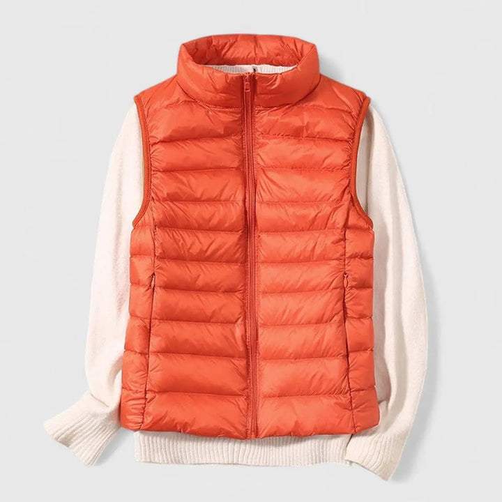 Women's lightweight quilted puffer vest in black, close-up of textured fabric and durable zipper.