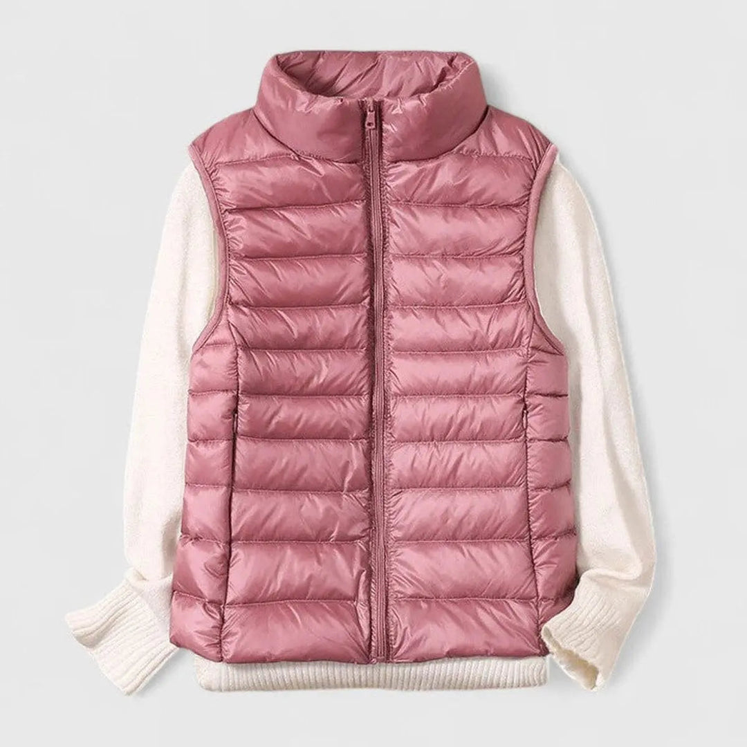 Model in a packable women's sleeveless puffer gilet, perfect for autumn layering and transitional fashion.