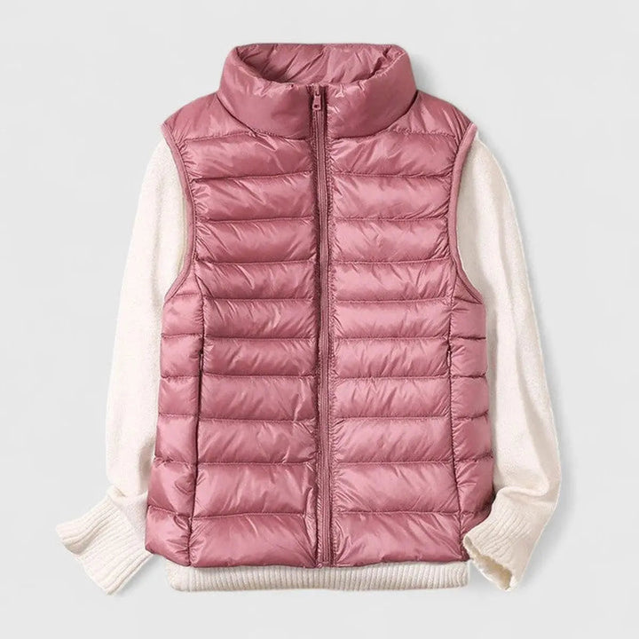 Model in a packable women's sleeveless puffer gilet, perfect for autumn layering and transitional fashion.