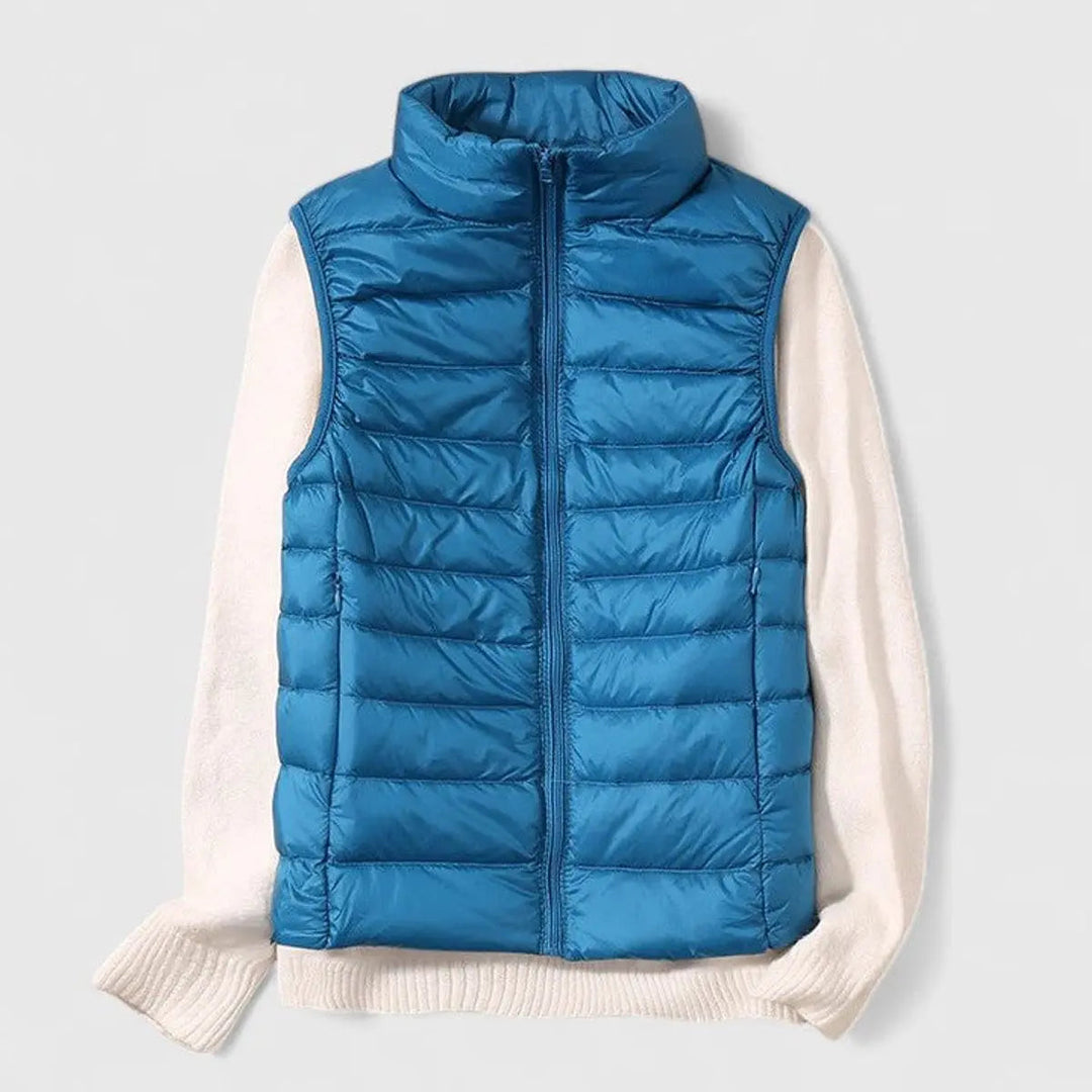 Versatile women's puffer vest in navy, stand collar, perfect as a lightweight sleeveless outer layer.