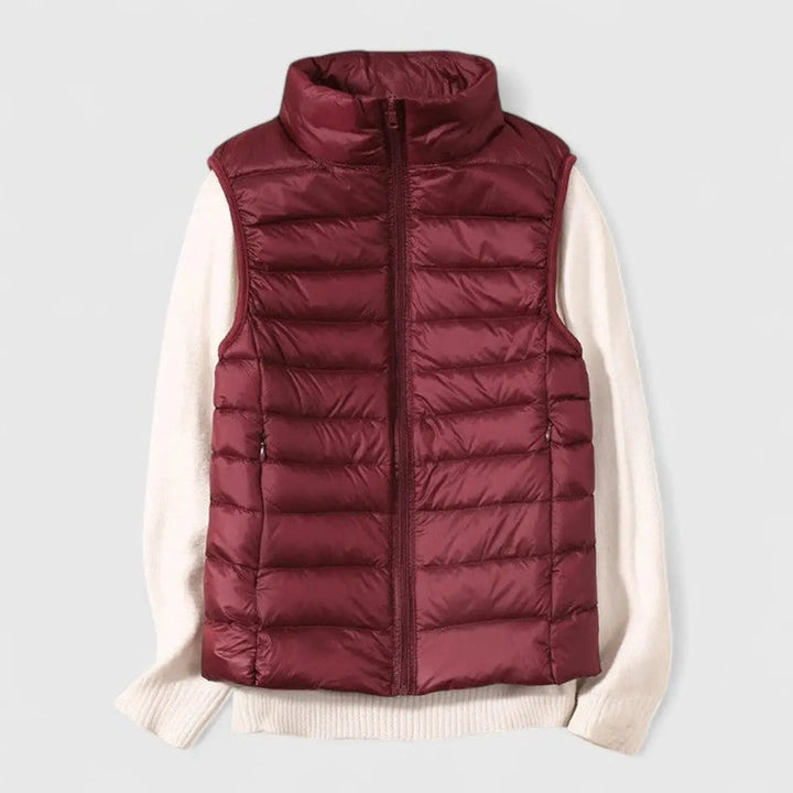 Folded lightweight women's puffer vest, demonstrating its packable feature for travel & convenience.