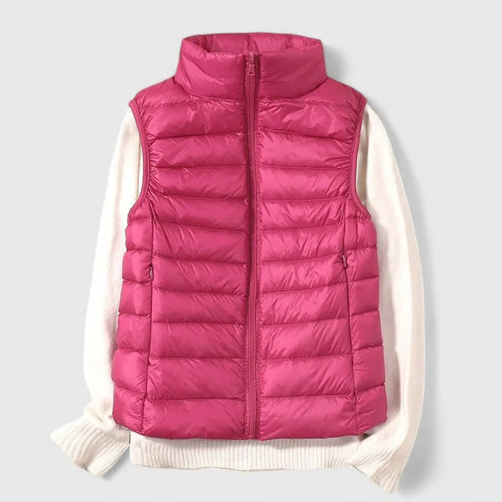 Detail of zipper and pockets on a women's quilted sleeveless vest, highlighting quality & functionality.