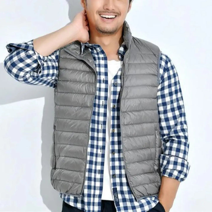 Lightweight quilted women's puffer vest, full zip, sleeveless for easy layering and transitional fashion.
