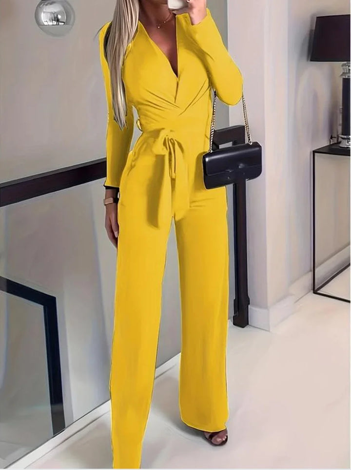 Versatile women's long-sleeve V-neck wide-leg jumpsuit with a tie-waist, ideal for casual comfort or dressy elegance.