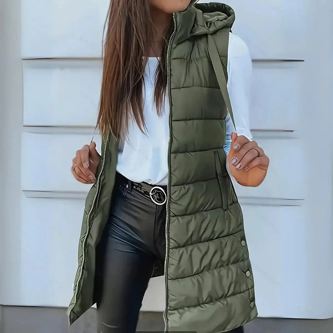 Women's hooded puffer vest, longline sleeveless jacket, lightweight outerwear for versatile fall/winter layering.