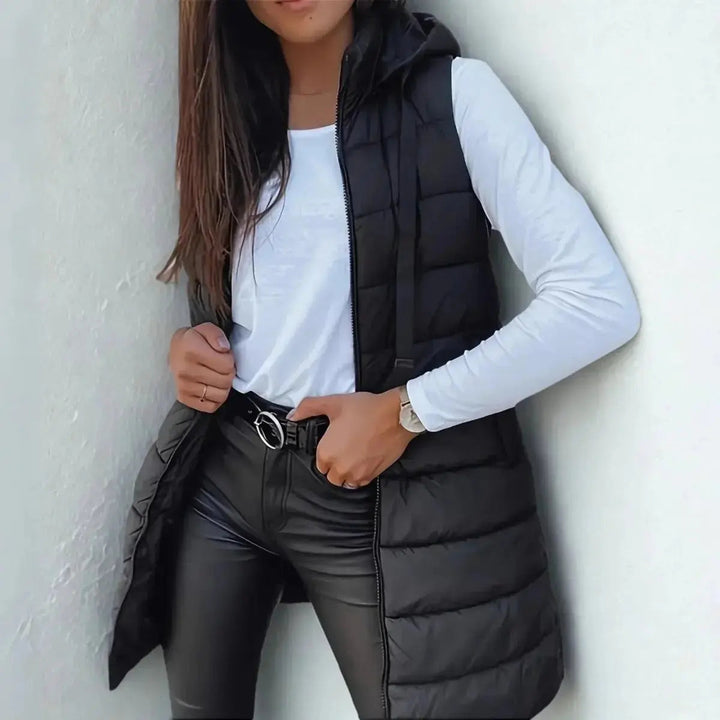 Women's chic longline hooded puffer vest, perfect for stylish fall & winter layering.