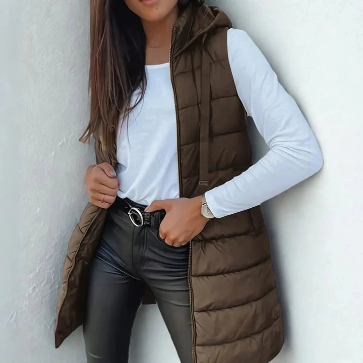 Stylish women's longline hooded puffer vest, an essential layering piece for casual fall & winter outfits.