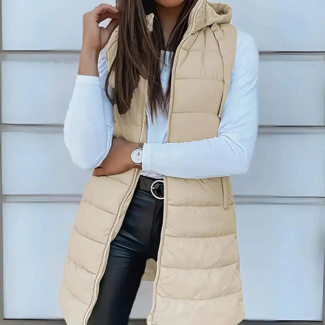 Lightweight & chic women's longline hooded puffer vest, a versatile sleeveless jacket for fall/winter.