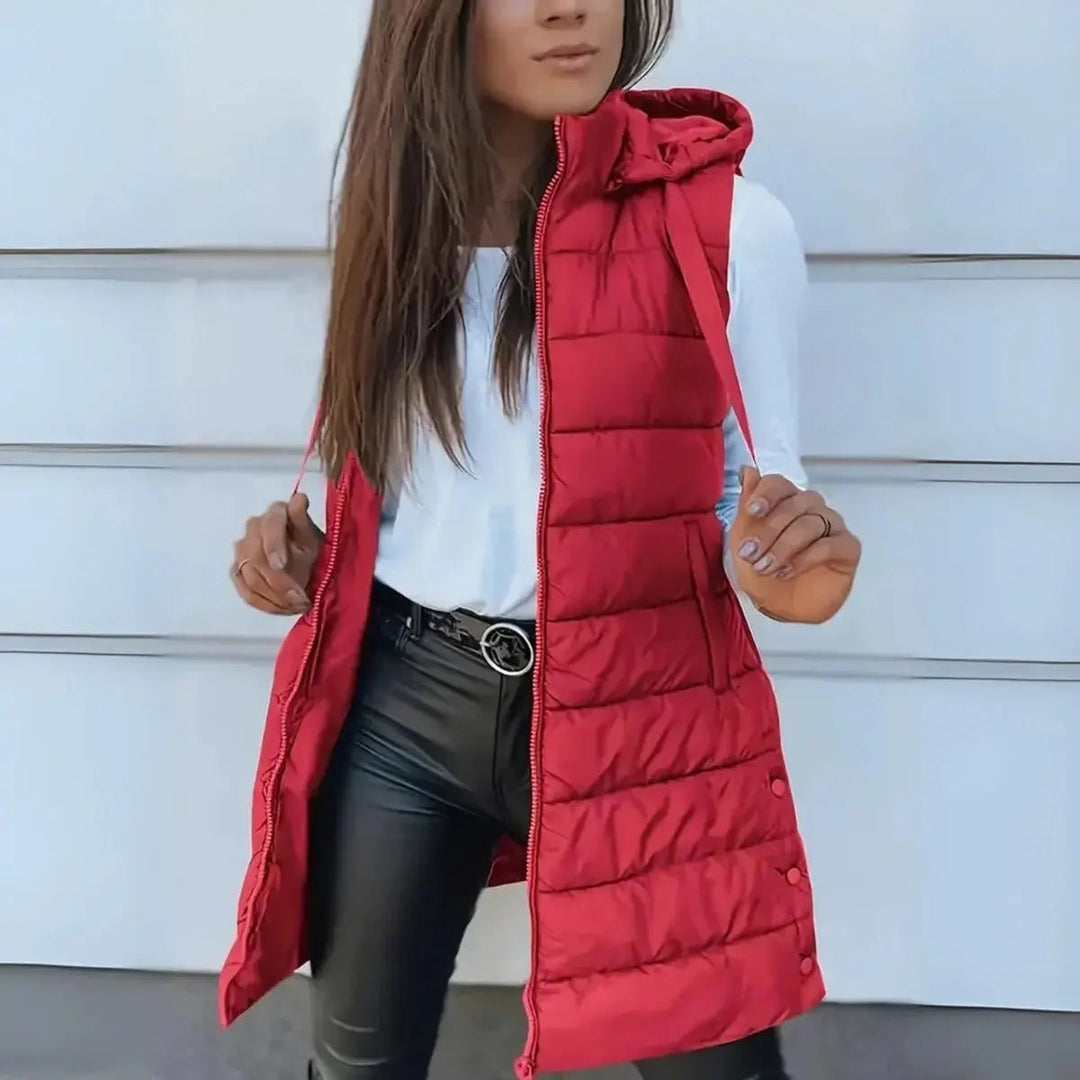 Women's fall/winter longline puffer vest with hood, a chic sleeveless outerwear for versatile layering.