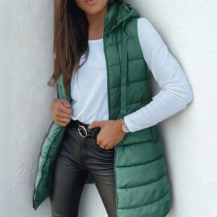 Versatile women's longline hooded puffer vest, a lightweight sleeveless jacket for stylish casual layering.