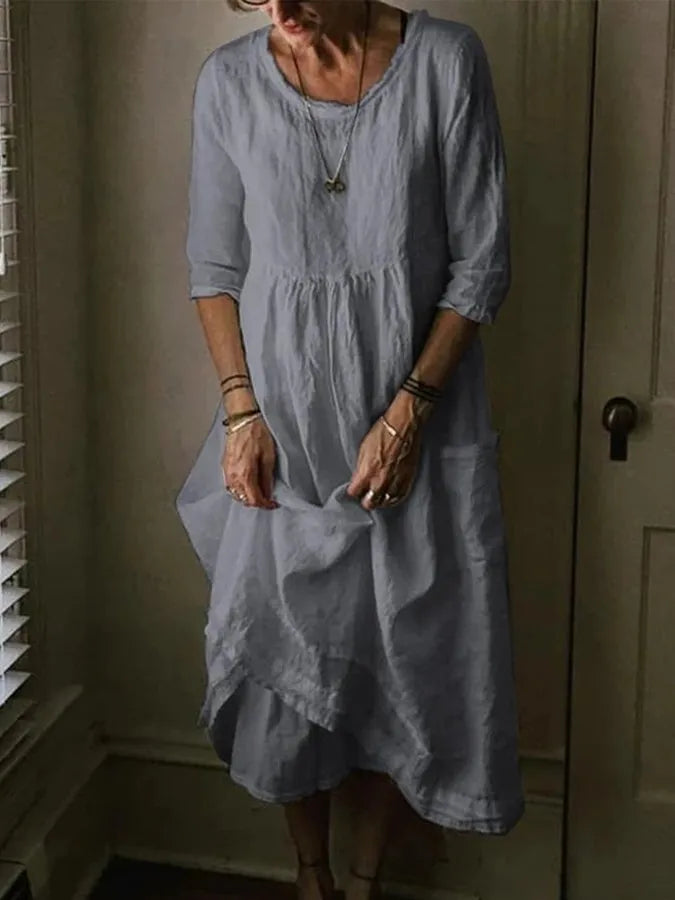 "Women's Loose Fit Cotton Linen Midi Dress with round neck, 3/4 sleeves, asymmetric hem, and pockets in various colors."