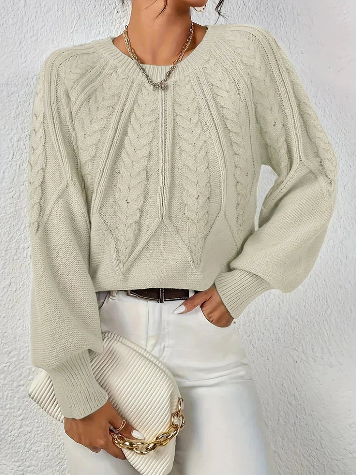 Women's cable knit crew neck sweater with voluminous sleeves, a modern fall fashion essential.
