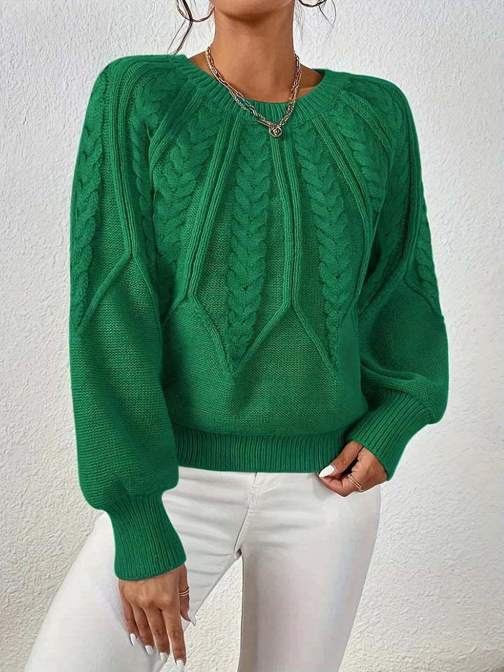 Warm women's cable knit crew neck sweater, stylish long-sleeve design for winter comfort and style.