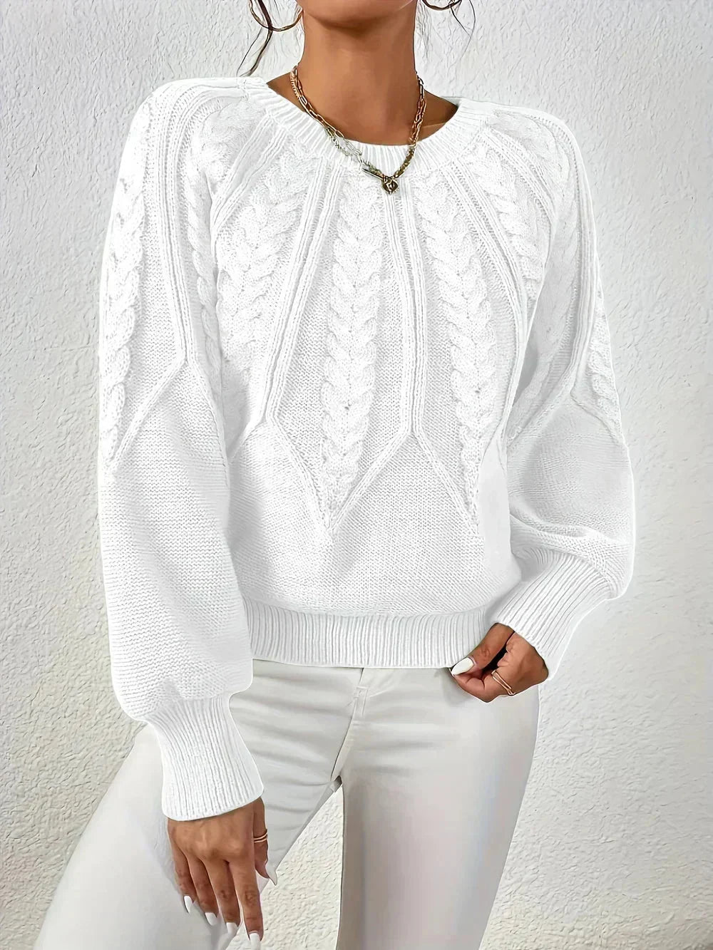 Women's cable knit crew neck sweater. Cozy long-sleeve design, an essential for fall winter fashion.