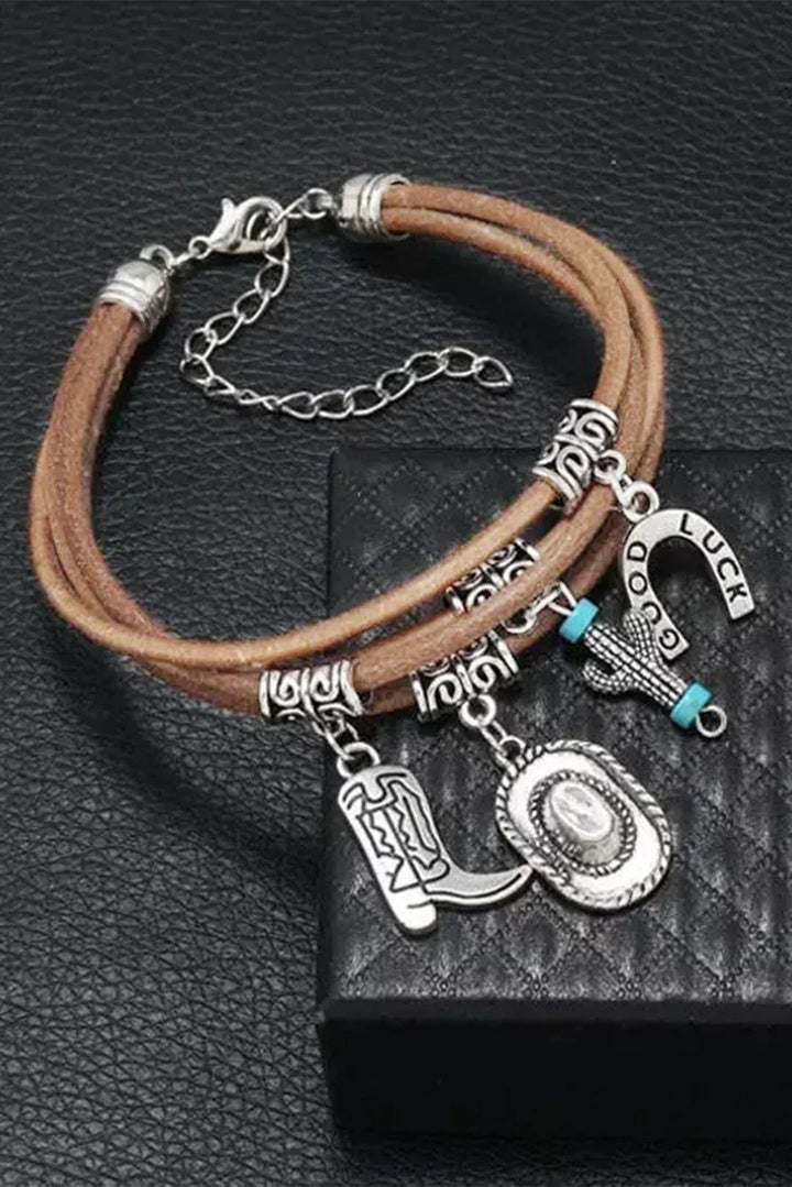 Dainty silver Western charm bracelet for women, showcasing detailed cowgirl hat, boot, and cactus symbols.