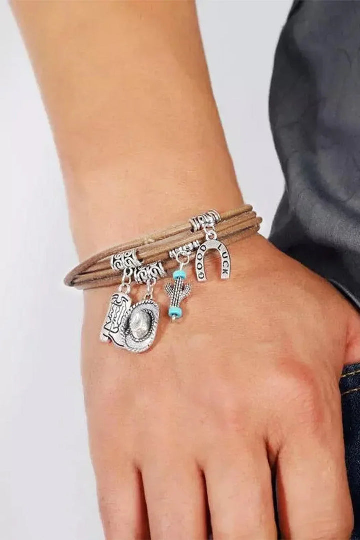 Elegant women's Western charm bracelet featuring silver hat, boot, and cactus charms. Stylish layered jewelry.