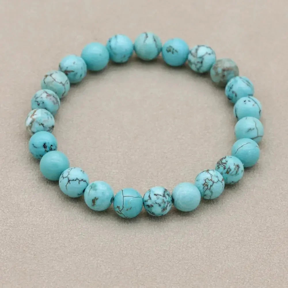 Close-up of a women's stretch bracelet featuring vibrant natural turquoise stone beads.