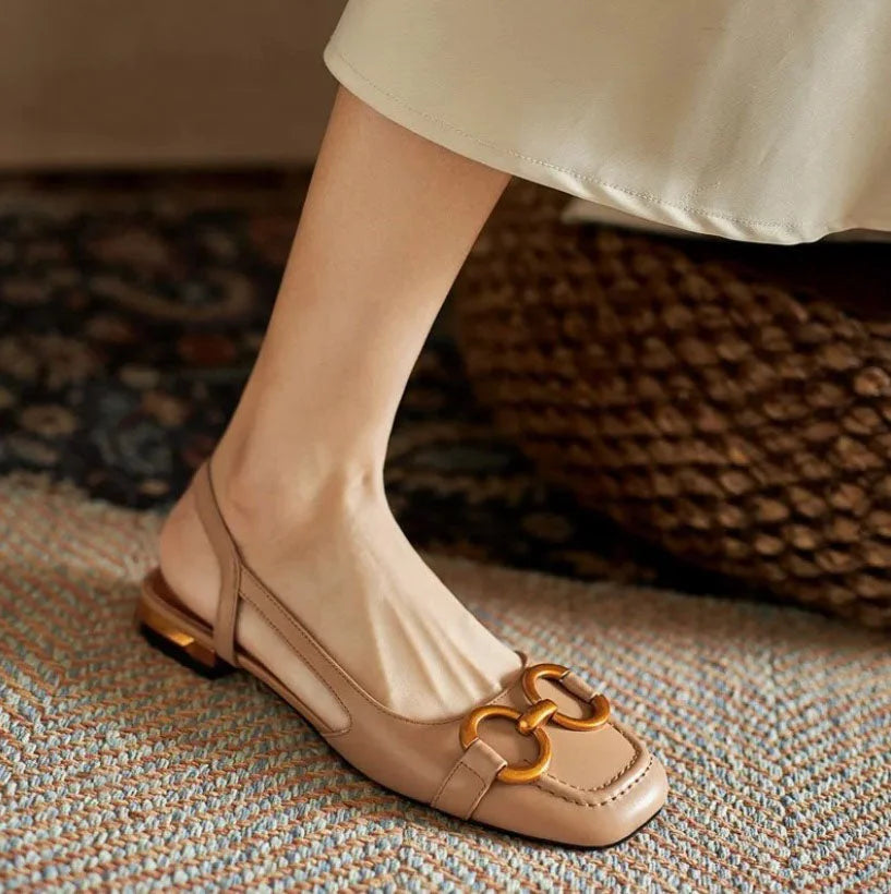 Elegant navy square-toe slingback sandals with a prominent gold buckle, comfortable women's flats.